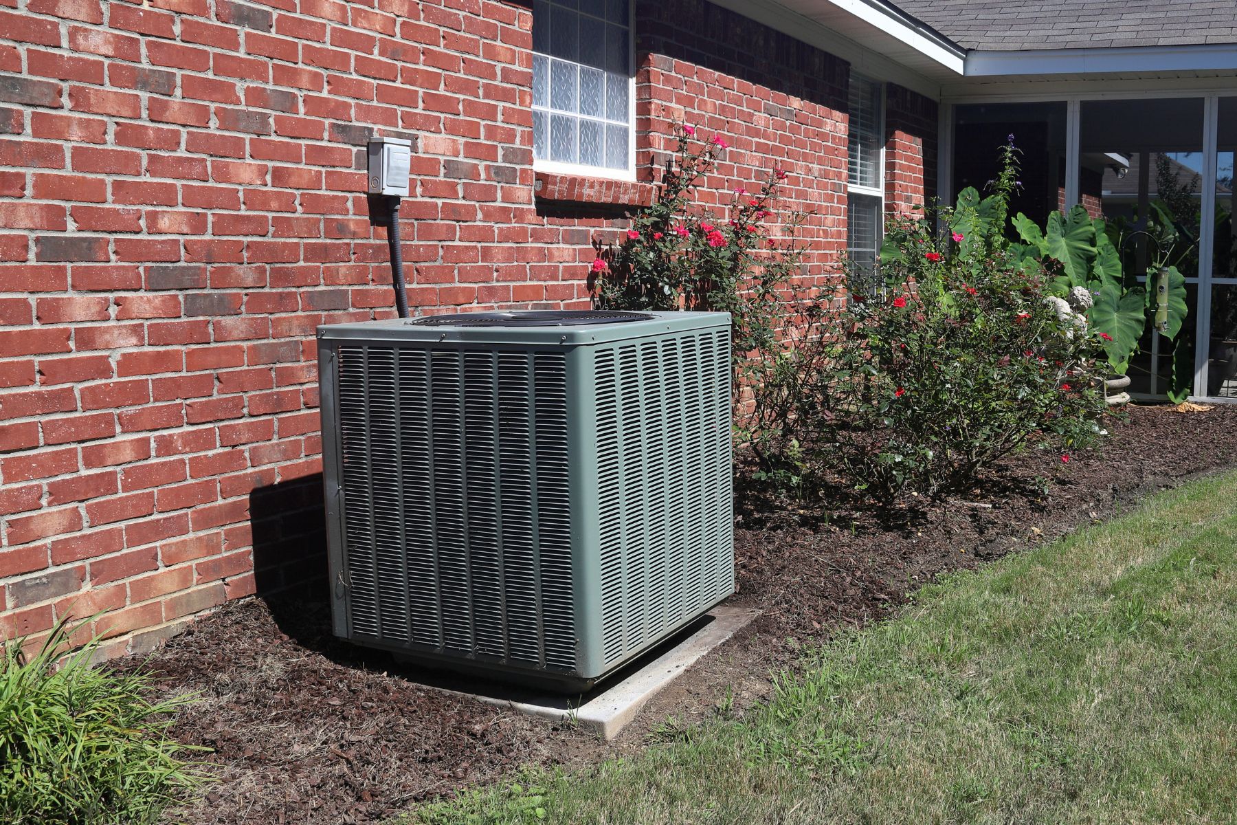HVAC technician servicing an outdoor AC unit at a Cullman home